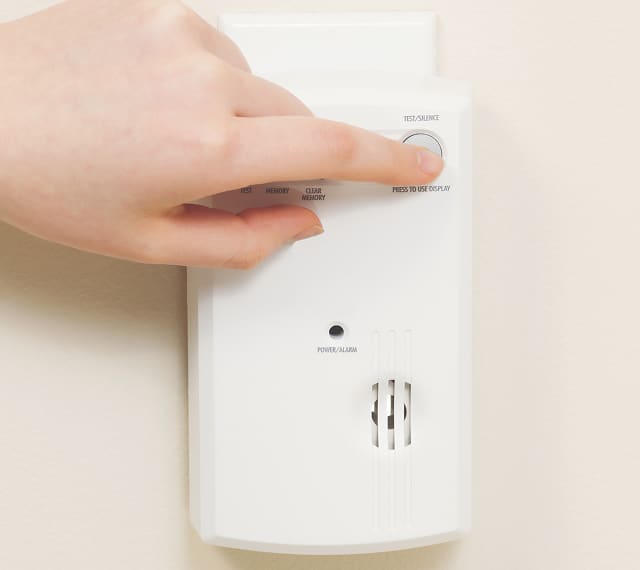 Hand pressing alarm button